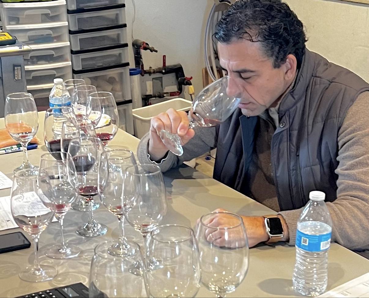 Guillermo Seta deep in the nose of a glass at the winery blending table