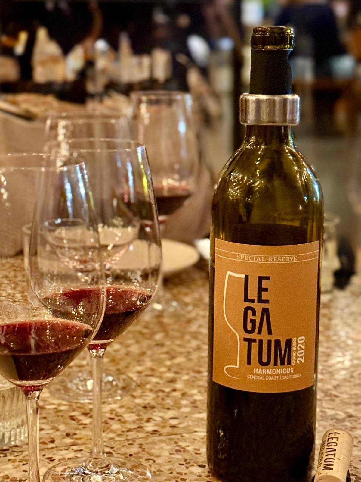 Legatum Harmonicus Special Reserve with glasses of red wine