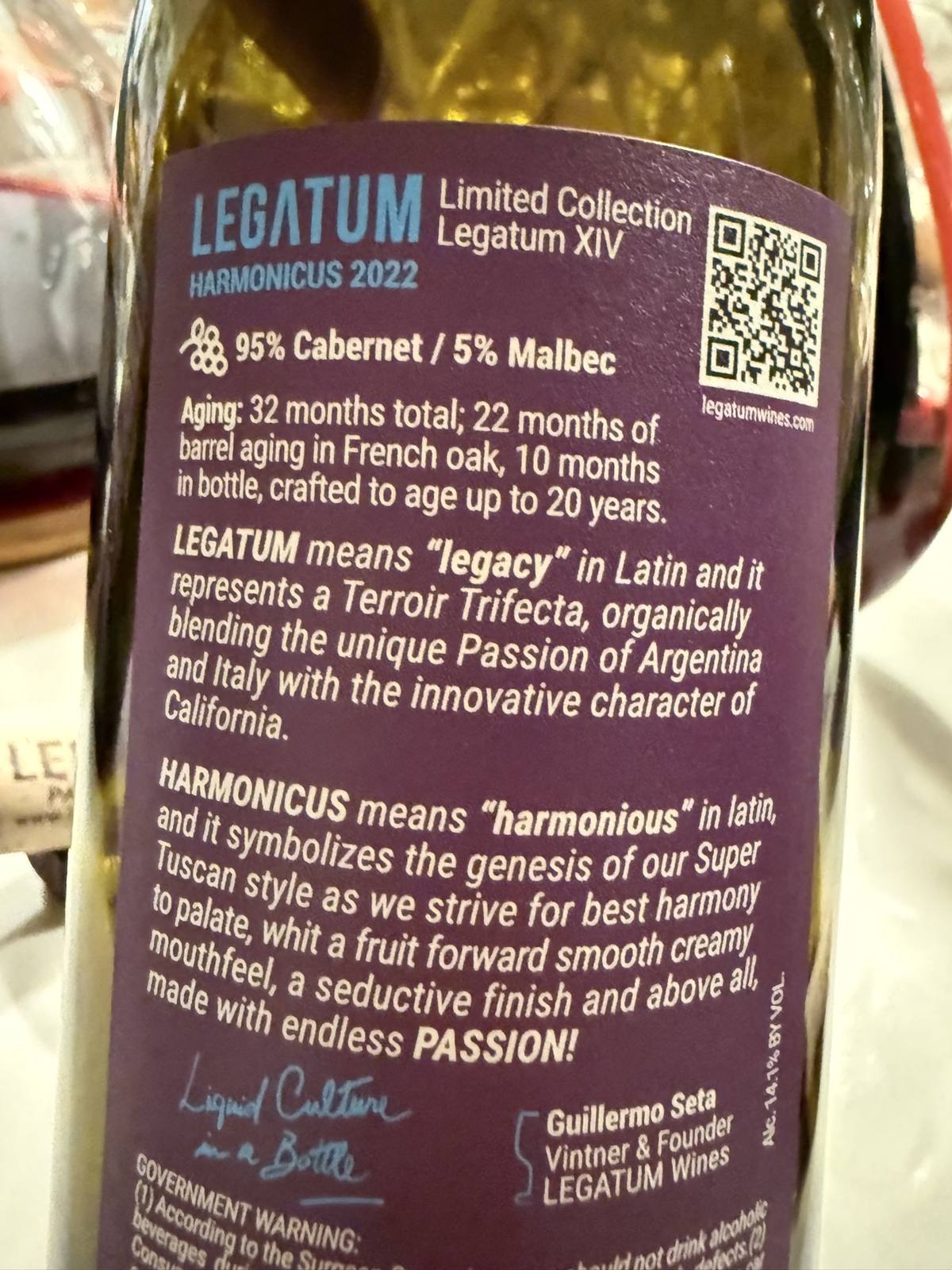 Close view of the 2022 Legatum XIV Harmonicus back label with its blend, aging, and founder signature