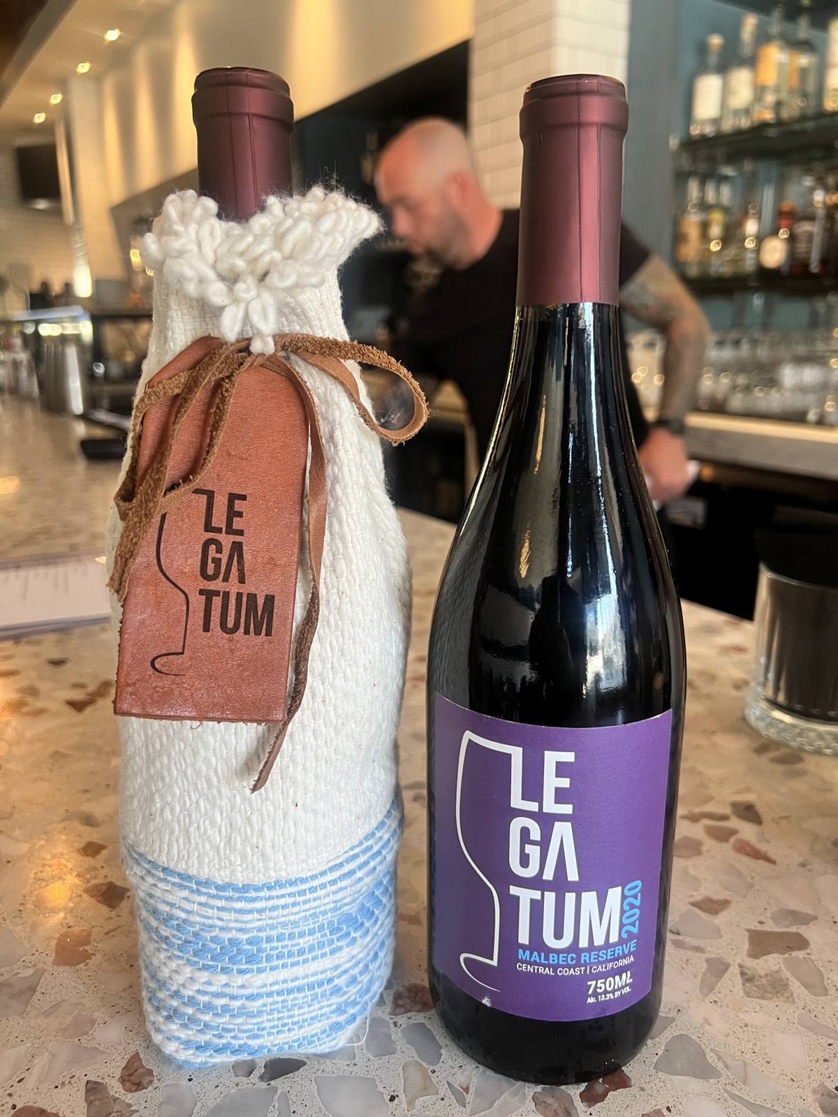 Purple-label 2020 Malbec Reserve beside the hand-woven sleeve and red leather tag