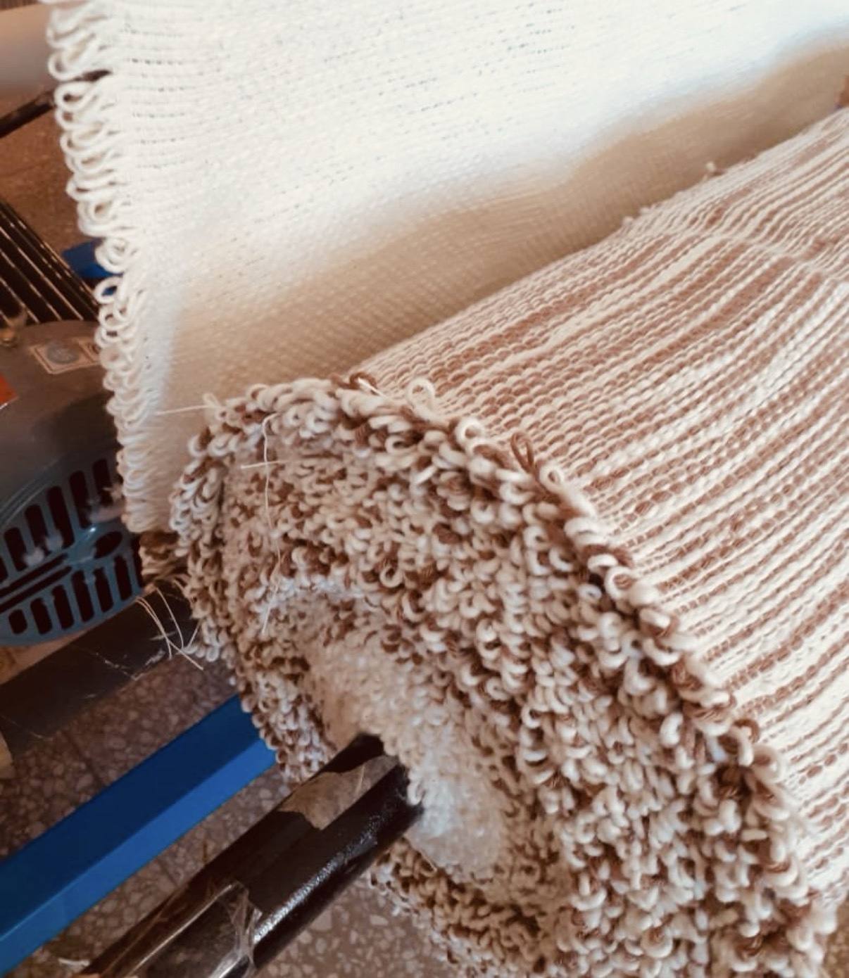 Close view of hand-woven textile rolls for the Legatum sleeves
