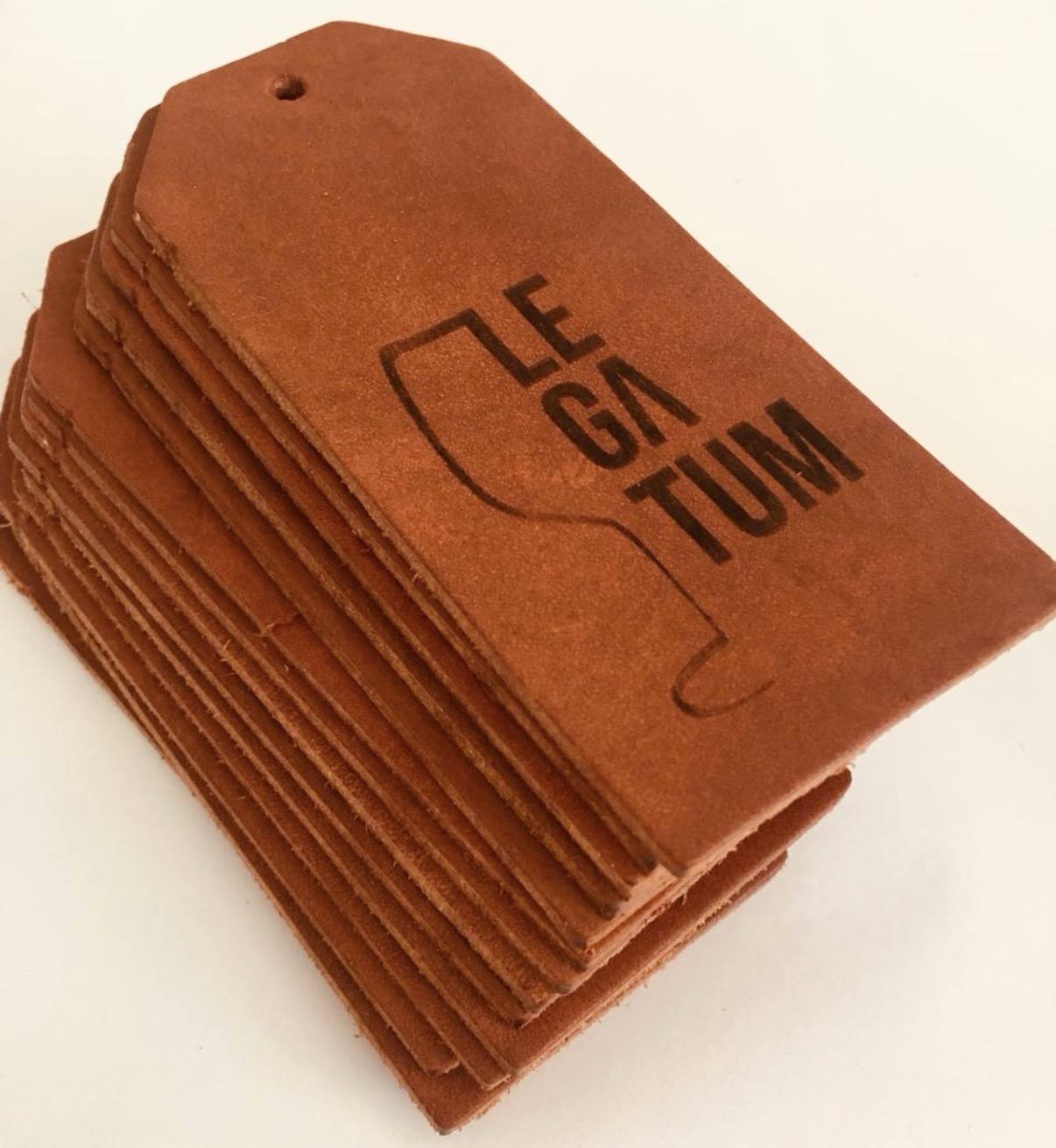 Stack of embossed leather Legatum tags