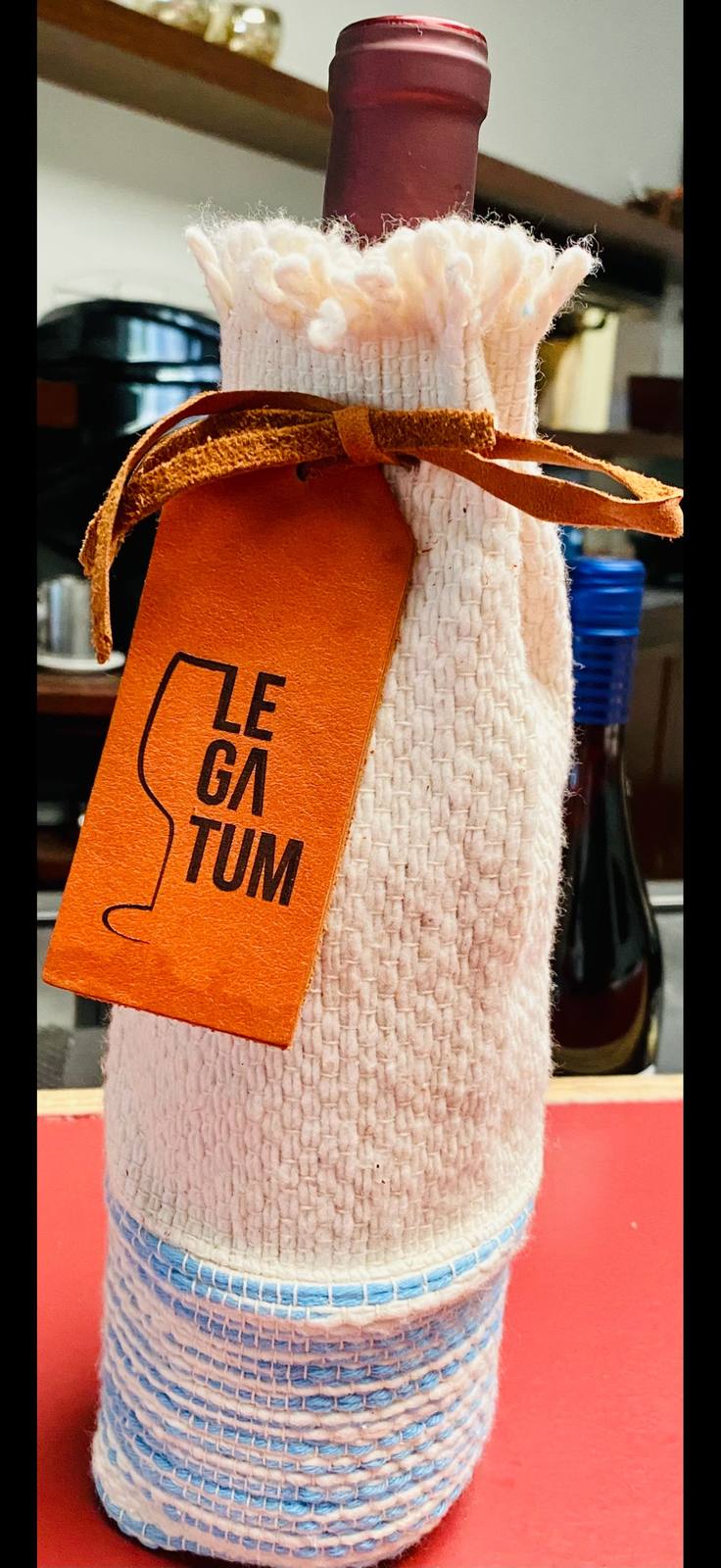 Finished Legatum bottle in a hand-woven white and pale-blue Argentinian sleeve with leather tag