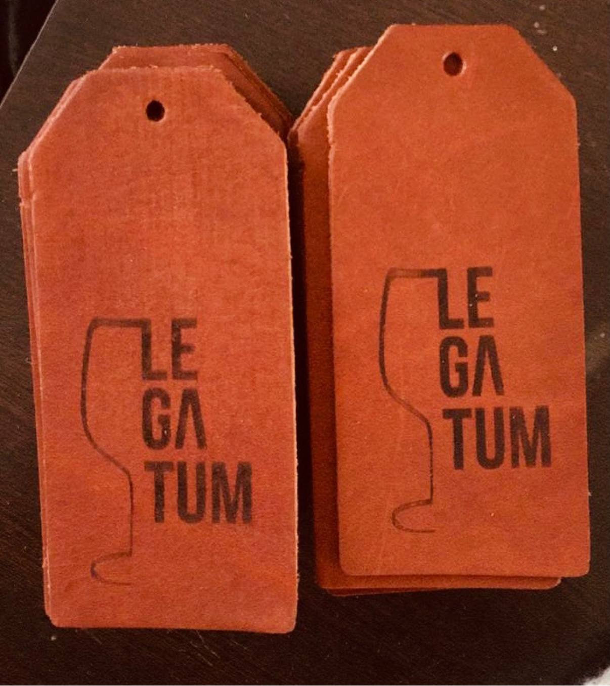 A stack of hand-cut brown leather Legatum tags stamped and ready for the sleeves