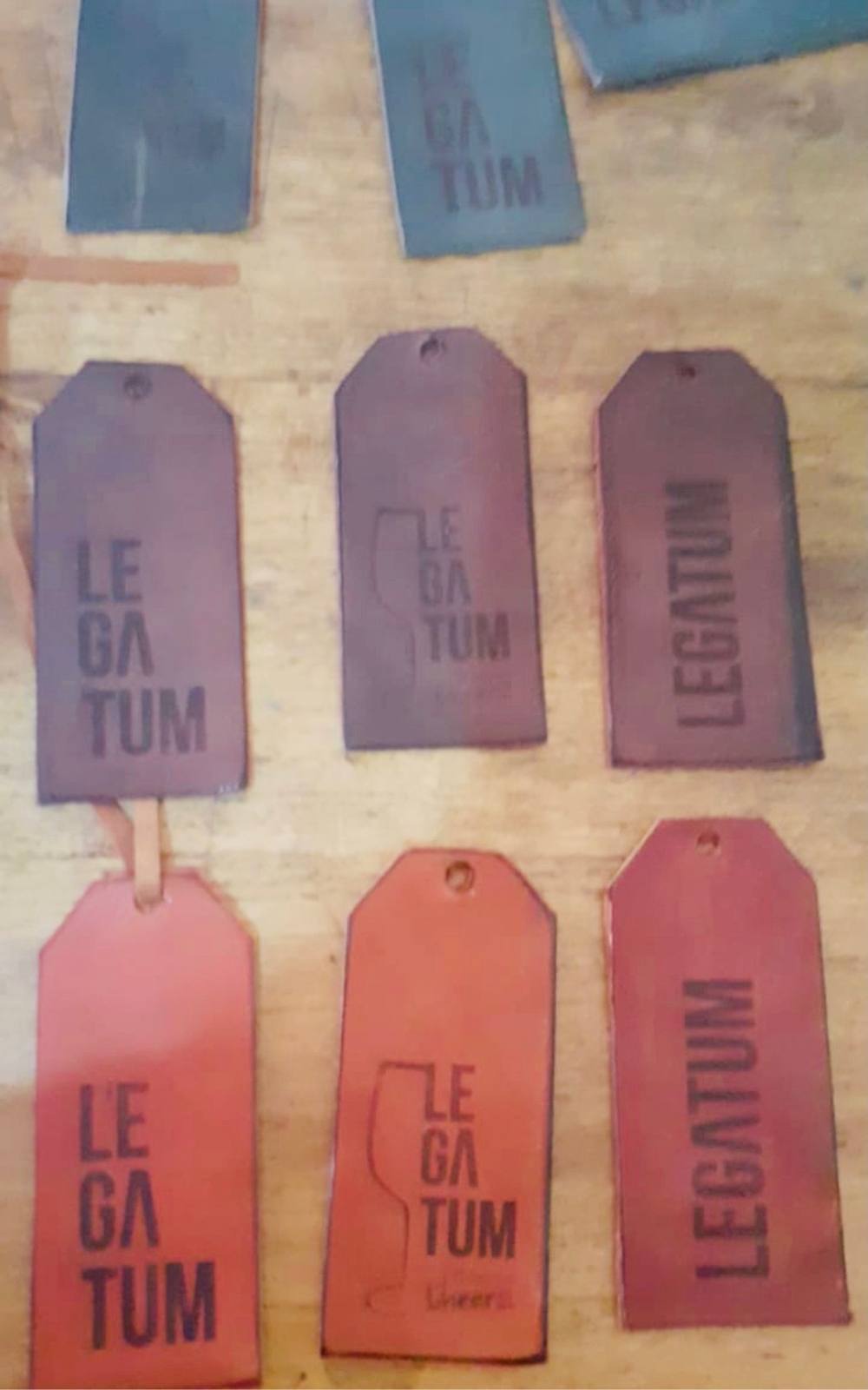 Red and brown embossed leather Legatum tags