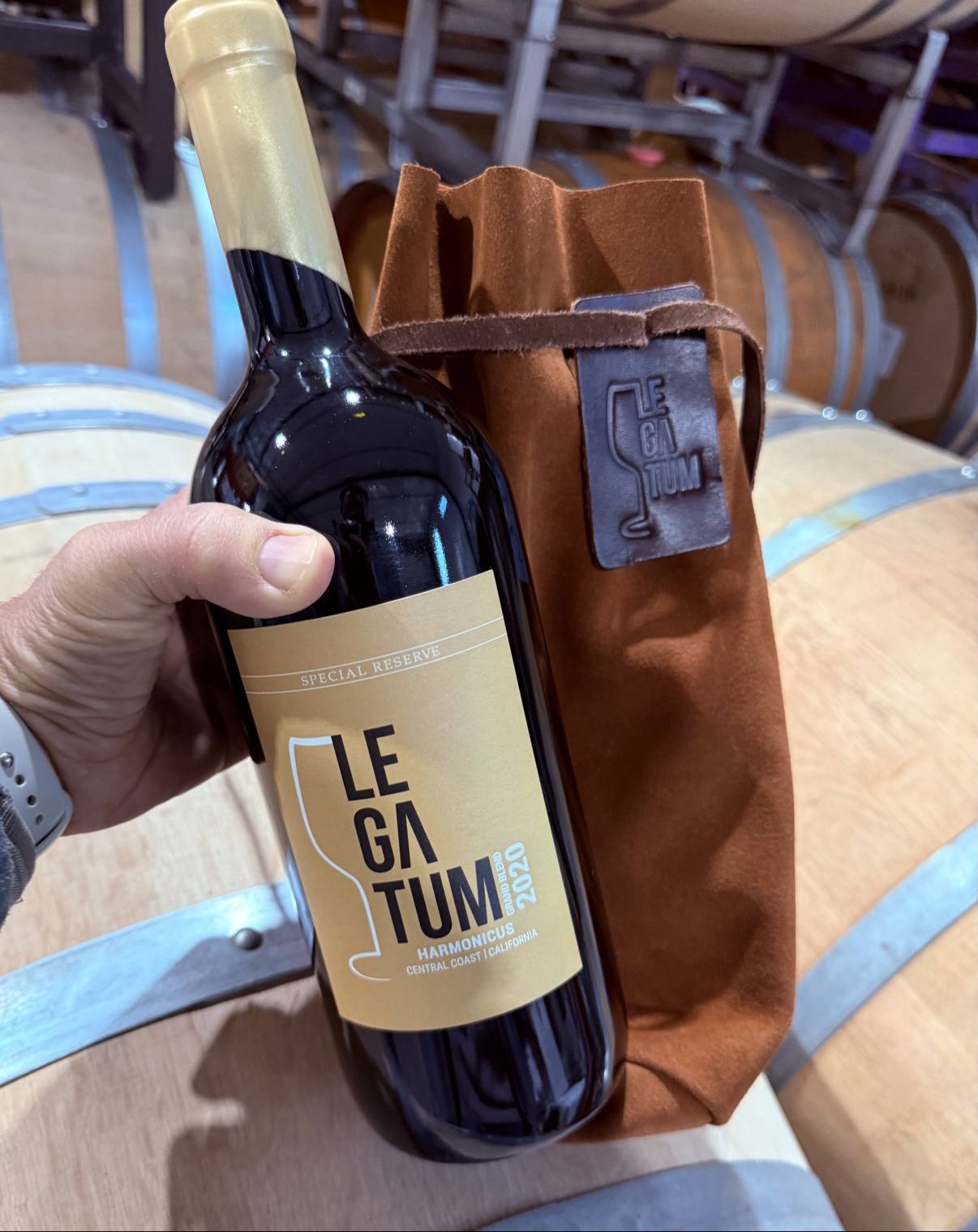 Legatum 2020 Harmonicus Special Reserve bottle beside its brown leather magnum sleeve