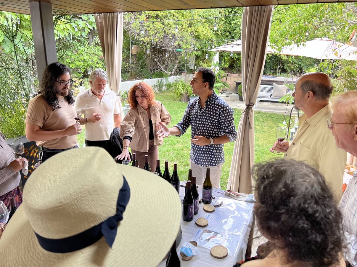 Guests gathered in a circle while Guillermo Seta tells the story of a bottle