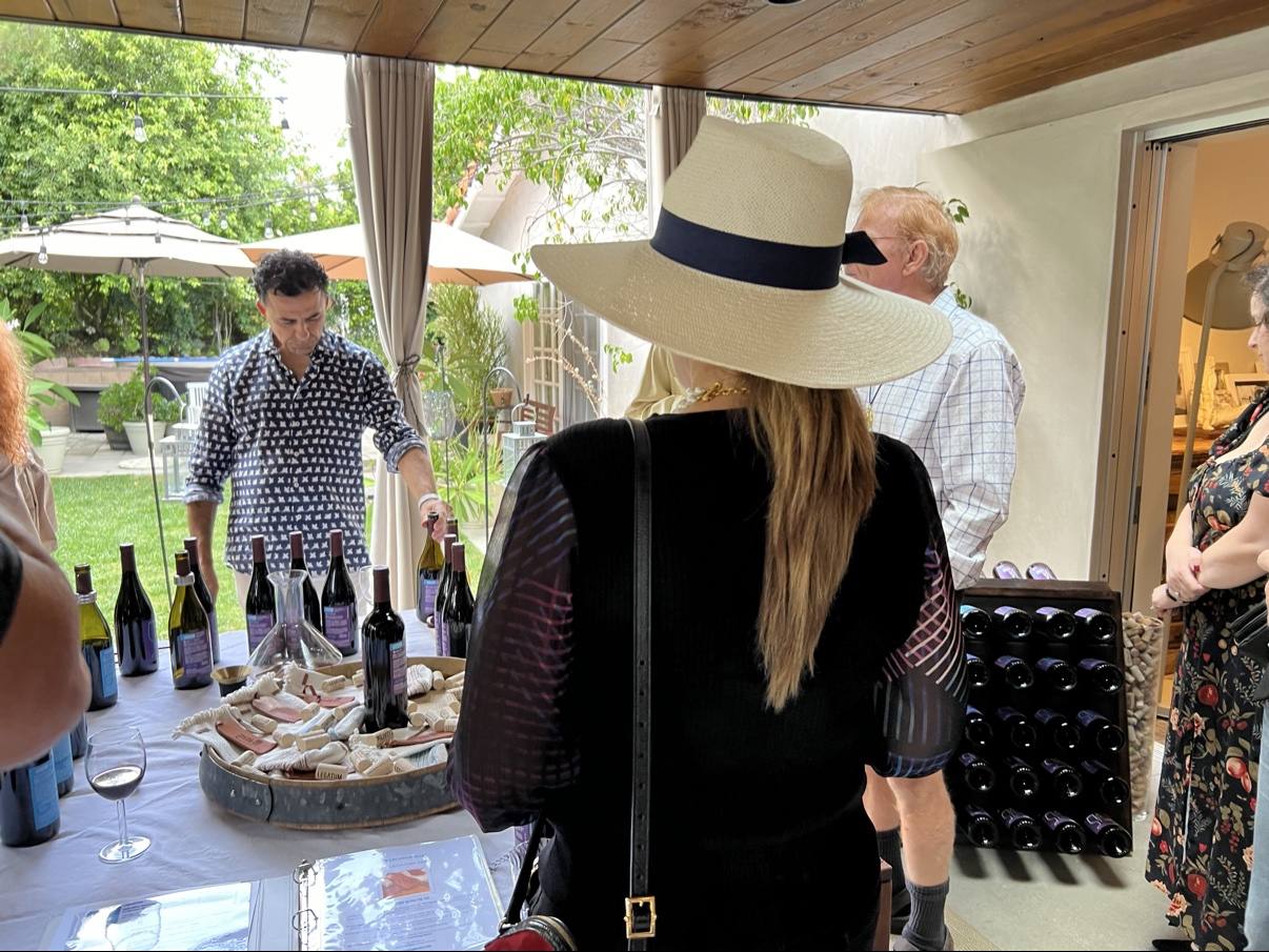 Tasting sheets, glasses, Legatum bottles, and a vase filled with corks on a private table