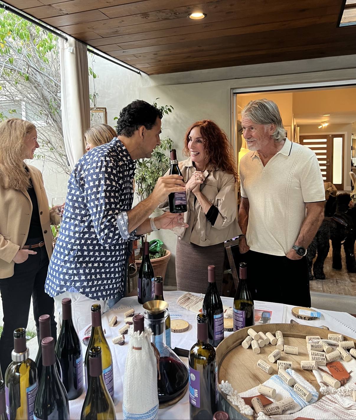 Guillermo Seta showing a Legatum bottle and its label to gathered guests