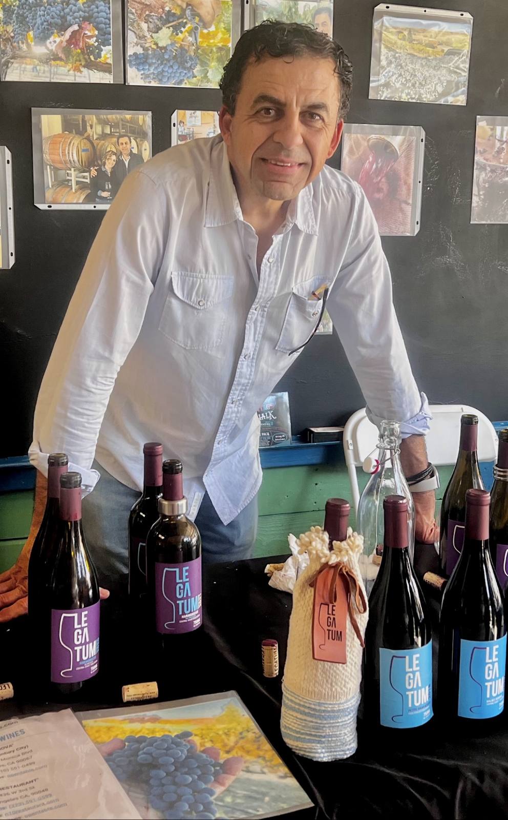 Guillermo Seta seated at the tango bar table with Legatum bottles and glasses