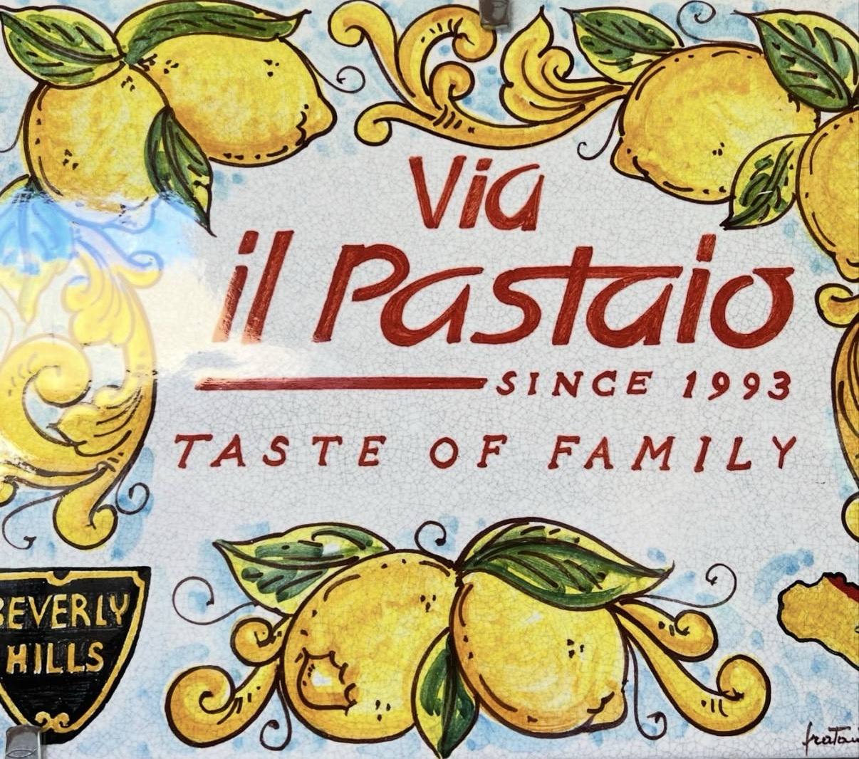 Painted Via il Pastaio since 1993 sign with lemons and the words Taste of Family