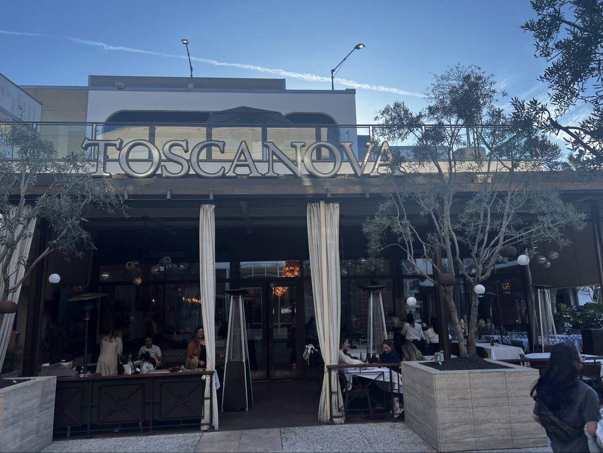 Front view of Toscanova with its terrace, olive trees, and dining room